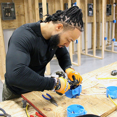 Student working with electrical boxes