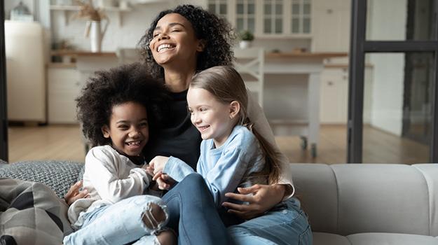 Foster family on laughing on couch